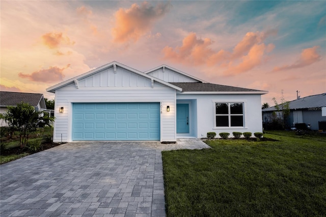 view of front facade with a garage and a yard