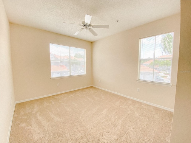 18001 Richmond Place Dr Unit 222, Tampa, FL 33647 - empty room featuring ceiling fan, light carpet, and a textured ceiling