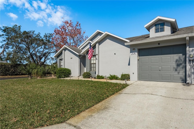 view of front of house with a garage and a front yard