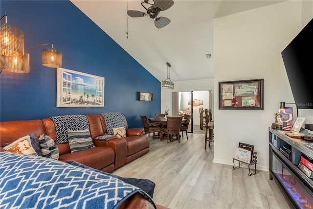 interior space with ceiling fan, high vaulted ceiling, and light hardwood / wood-style flooring