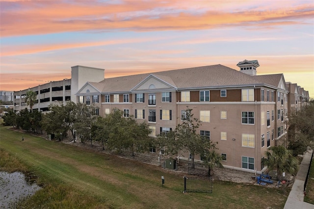 outdoor building at dusk featuring cooling unit