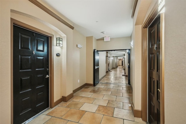 hall featuring light tile patterned floors