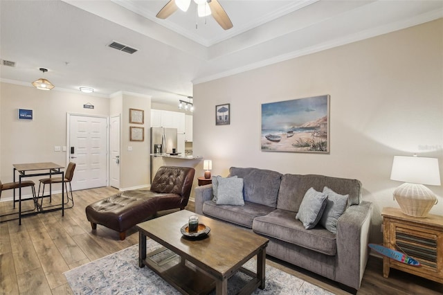 4221 W Spruce St Unit 1414, Tampa, FL 33607 - living room featuring ceiling fan, ornamental molding, a tray ceiling, and light hardwood / wood-style flooring