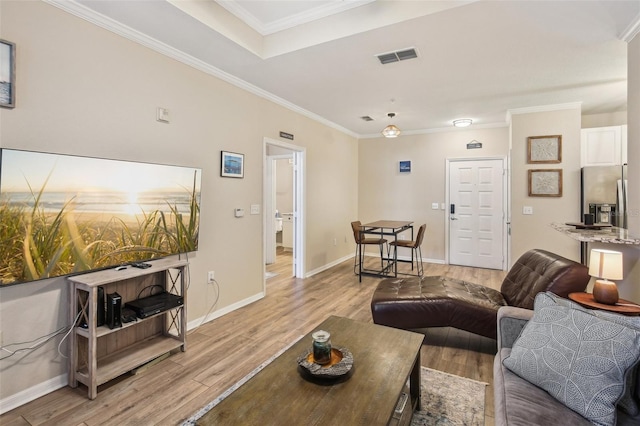 4221 W Spruce St Unit 1414, Tampa, FL 33607 - living room featuring crown molding and light hardwood / wood-style flooring