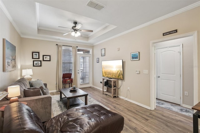 4221 W Spruce St Unit 1414, Tampa, FL 33607 - living room with crown molding, a raised ceiling, and light hardwood / wood-style flooring