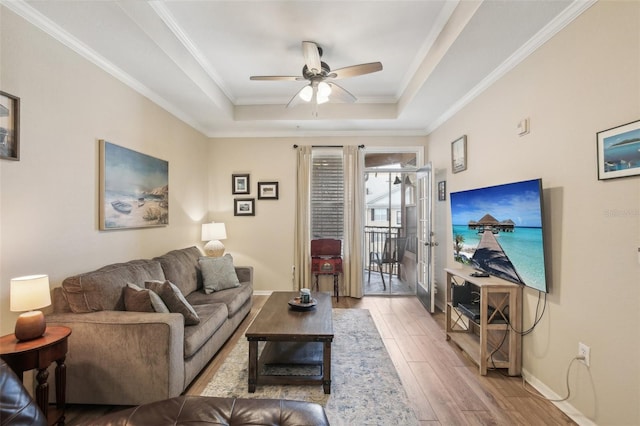 4221 W Spruce St Unit 1414, Tampa, FL 33607 - living room with crown molding, a tray ceiling, light hardwood / wood-style floors, and ceiling fan
