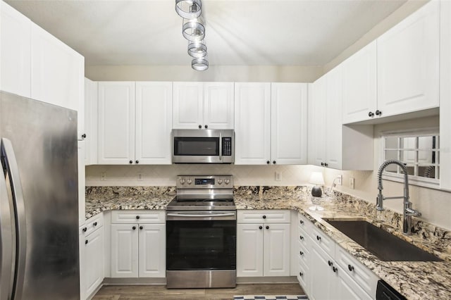 4221 W Spruce St Unit 1414, Tampa, FL 33607 - kitchen with stainless steel appliances, sink, and white cabinets