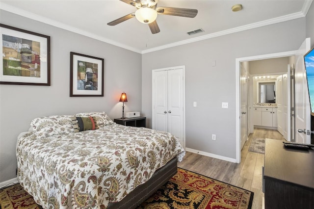 4221 W Spruce St Unit 1414, Tampa, FL 33607 - bedroom with ceiling fan, ornamental molding, light hardwood / wood-style floors, and a closet
