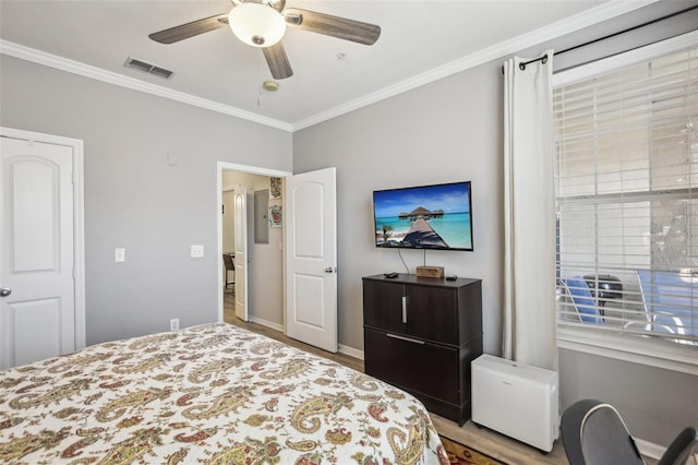 4221 W Spruce St Unit 1414, Tampa, FL 33607 - bedroom with ornamental molding, ceiling fan, and light hardwood / wood-style flooring