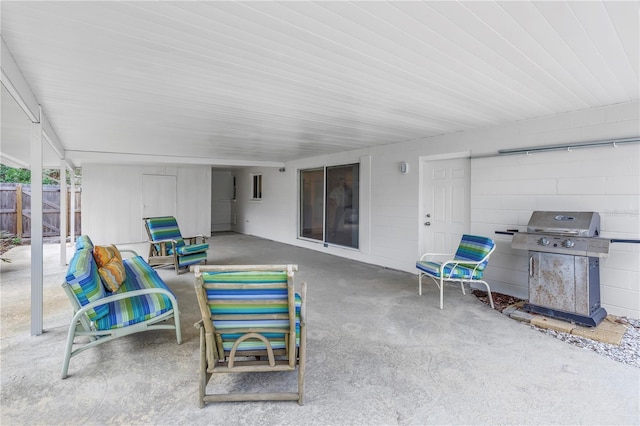 view of patio with area for grilling and fence