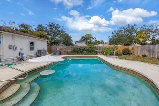 view of swimming pool with a fenced backyard, cooling unit, a fenced in pool, and a patio