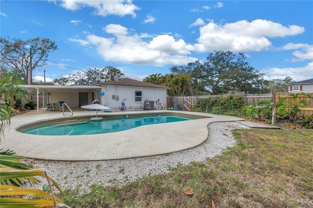 view of swimming pool with a fenced in pool, a fenced backyard, and a patio