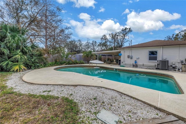 view of pool with a fenced in pool, a fenced backyard, a patio, and central AC unit