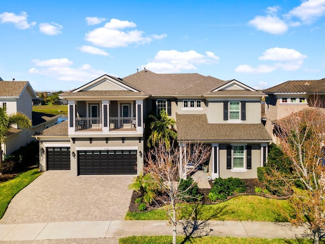 view of front of house featuring a balcony and a garage