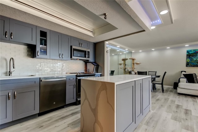 7432 Sunshine Skyway Ln S Unit 206, Saint Petersburg, FL 33711 - kitchen with sink, stainless steel appliances, gray cabinetry, and a center island