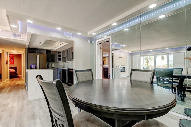 7432 Sunshine Skyway Ln S Unit 206, Saint Petersburg, FL 33711 - dining area featuring light wood-type flooring and sink