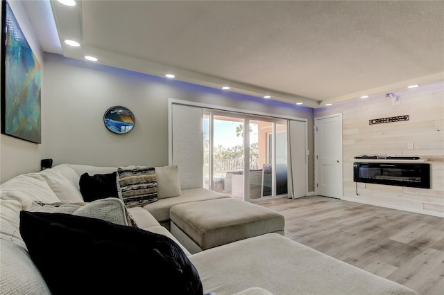 7432 Sunshine Skyway Ln S Unit 206, Saint Petersburg, FL 33711 - living room featuring a tile fireplace and light hardwood / wood-style flooring