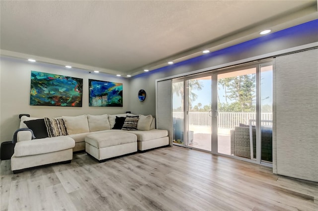 7432 Sunshine Skyway Ln S Unit 206, Saint Petersburg, FL 33711 - living room featuring french doors and light hardwood / wood-style flooring