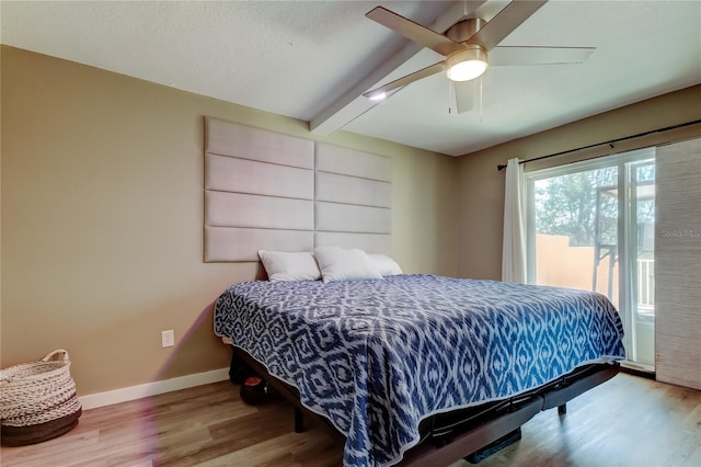7432 Sunshine Skyway Ln S Unit 206, Saint Petersburg, FL 33711 - bedroom featuring hardwood / wood-style flooring, ceiling fan, access to exterior, and beam ceiling