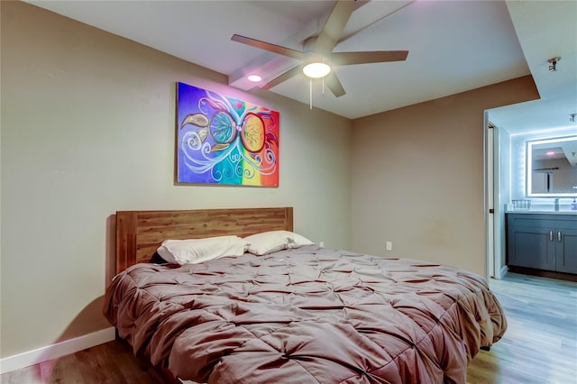 7432 Sunshine Skyway Ln S Unit 206, Saint Petersburg, FL 33711 - bedroom featuring ensuite bathroom, light wood-type flooring, sink, and ceiling fan