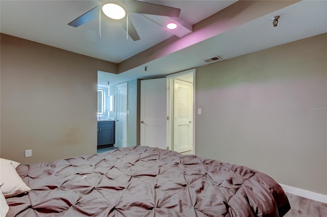7432 Sunshine Skyway Ln S Unit 206, Saint Petersburg, FL 33711 - unfurnished bedroom featuring ceiling fan, light hardwood / wood-style floors, and ensuite bathroom