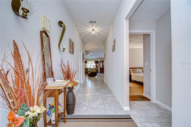 hallway with light tile patterned floors