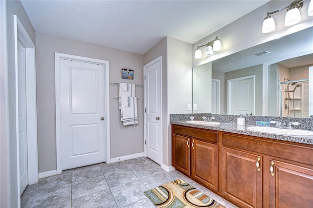 bathroom featuring walk in shower, tile patterned floors, and vanity