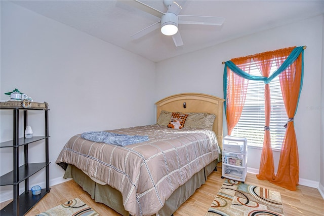 bedroom with ceiling fan and light hardwood / wood-style floors