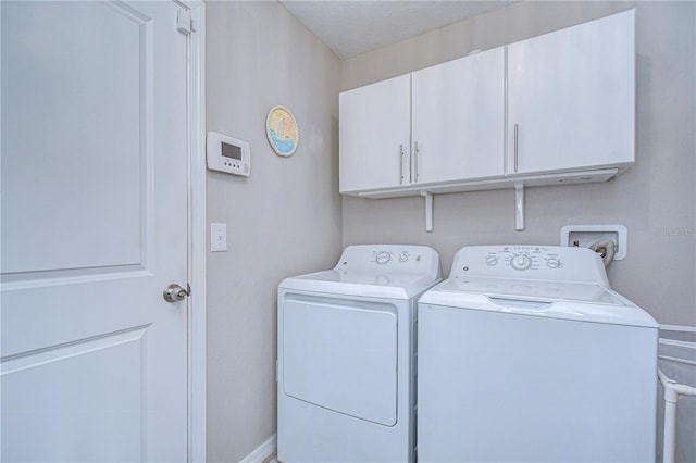 laundry area featuring cabinets and washing machine and dryer