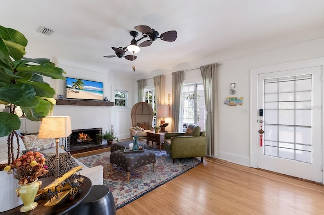 living room featuring light hardwood / wood-style flooring and ceiling fan