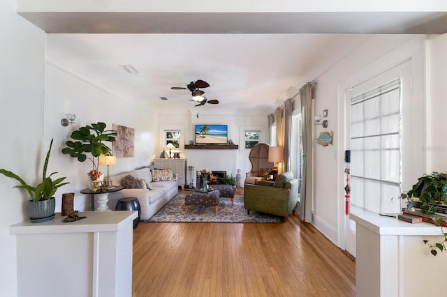 living room with ceiling fan and light wood-type flooring