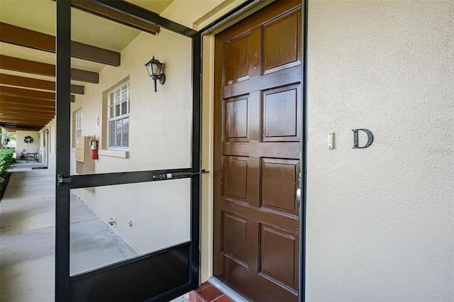 property entrance with stucco siding