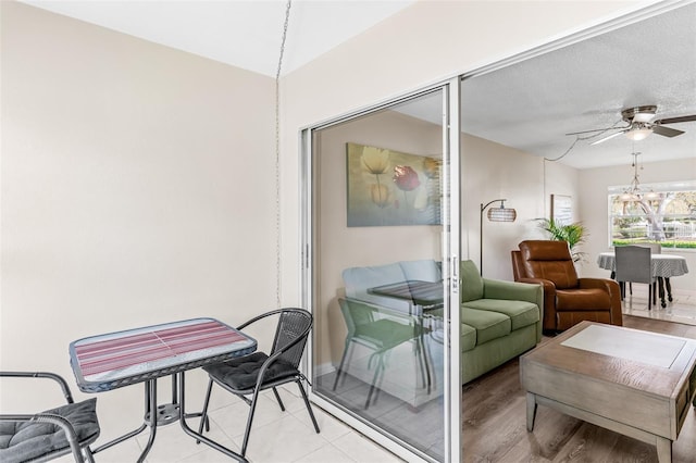 interior space featuring baseboards and a ceiling fan