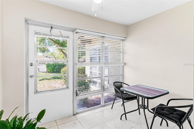 dining area featuring light tile patterned flooring and a ceiling fan