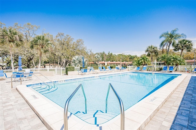 pool featuring a patio and fence