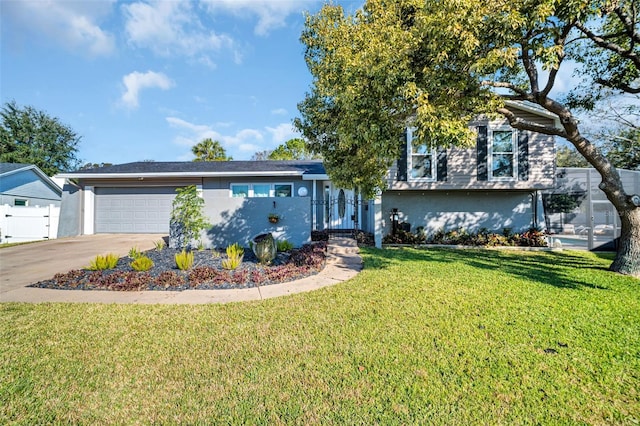 view of front of home with a front yard and a garage