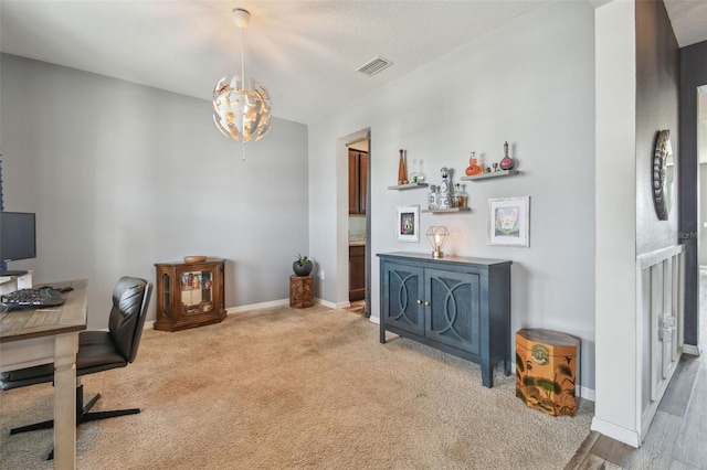 office featuring an inviting chandelier and carpet flooring