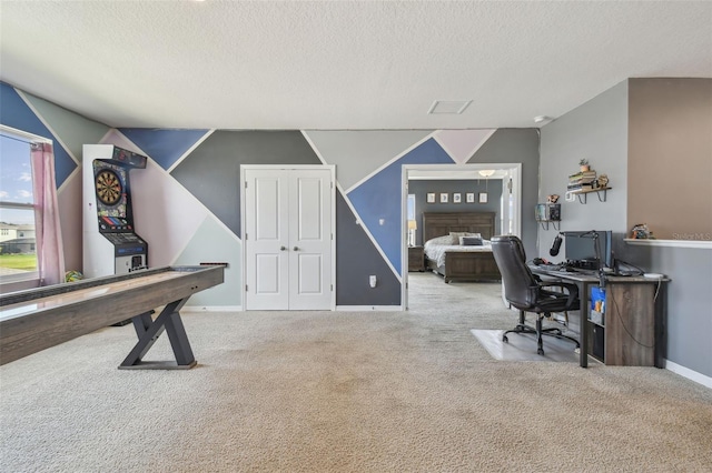 home office featuring light carpet and a textured ceiling