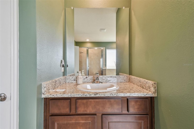 bathroom featuring vanity and an enclosed shower