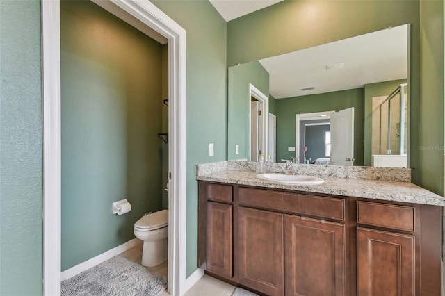 bathroom with vanity, tile patterned floors, and toilet