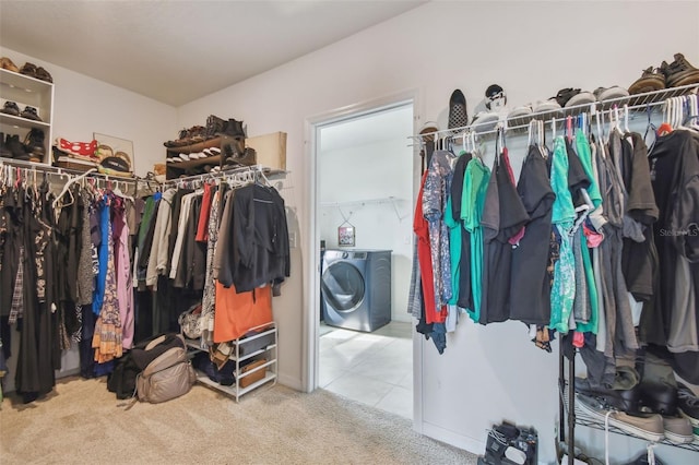 spacious closet with washer / dryer and carpet floors