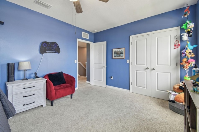 sitting room featuring ceiling fan and light carpet