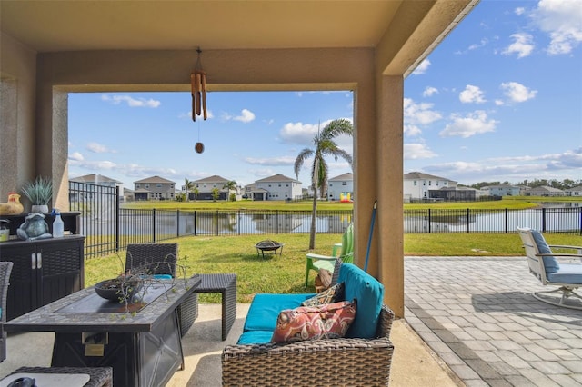 view of patio / terrace featuring an outdoor fire pit and a water view