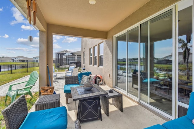 exterior space featuring an outdoor hangout area and glass enclosure