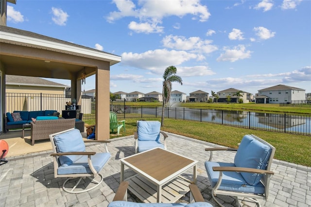 view of patio featuring an outdoor living space and a water view