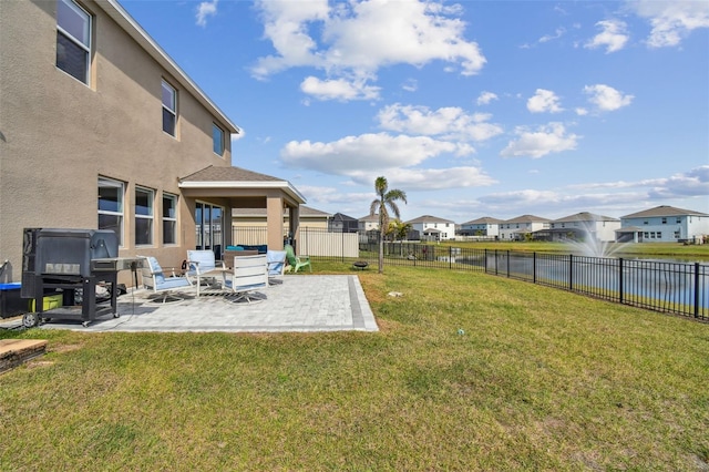 view of yard with a water view and a patio area