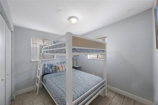 9169 Robin Rd, Seminole, FL 33777 - bedroom with a closet and a textured ceiling