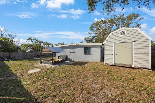 9169 Robin Rd, Seminole, FL 33777 - back of house featuring a storage shed and a lawn