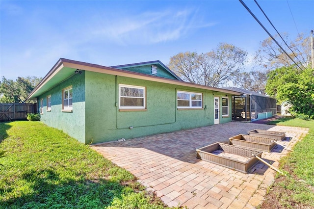 back of house with a yard, a lanai, and a patio area