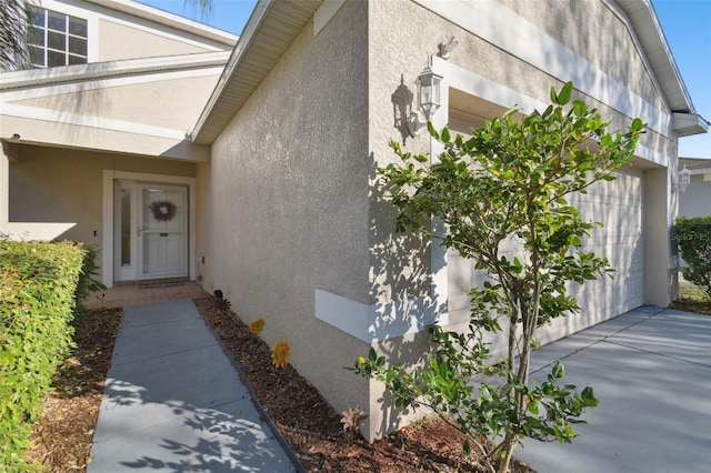 doorway to property with a garage